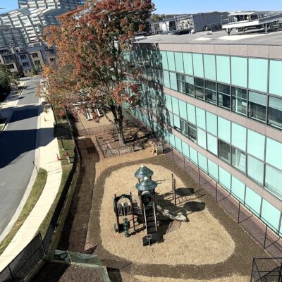 Aerial view of fenced playground area along the building